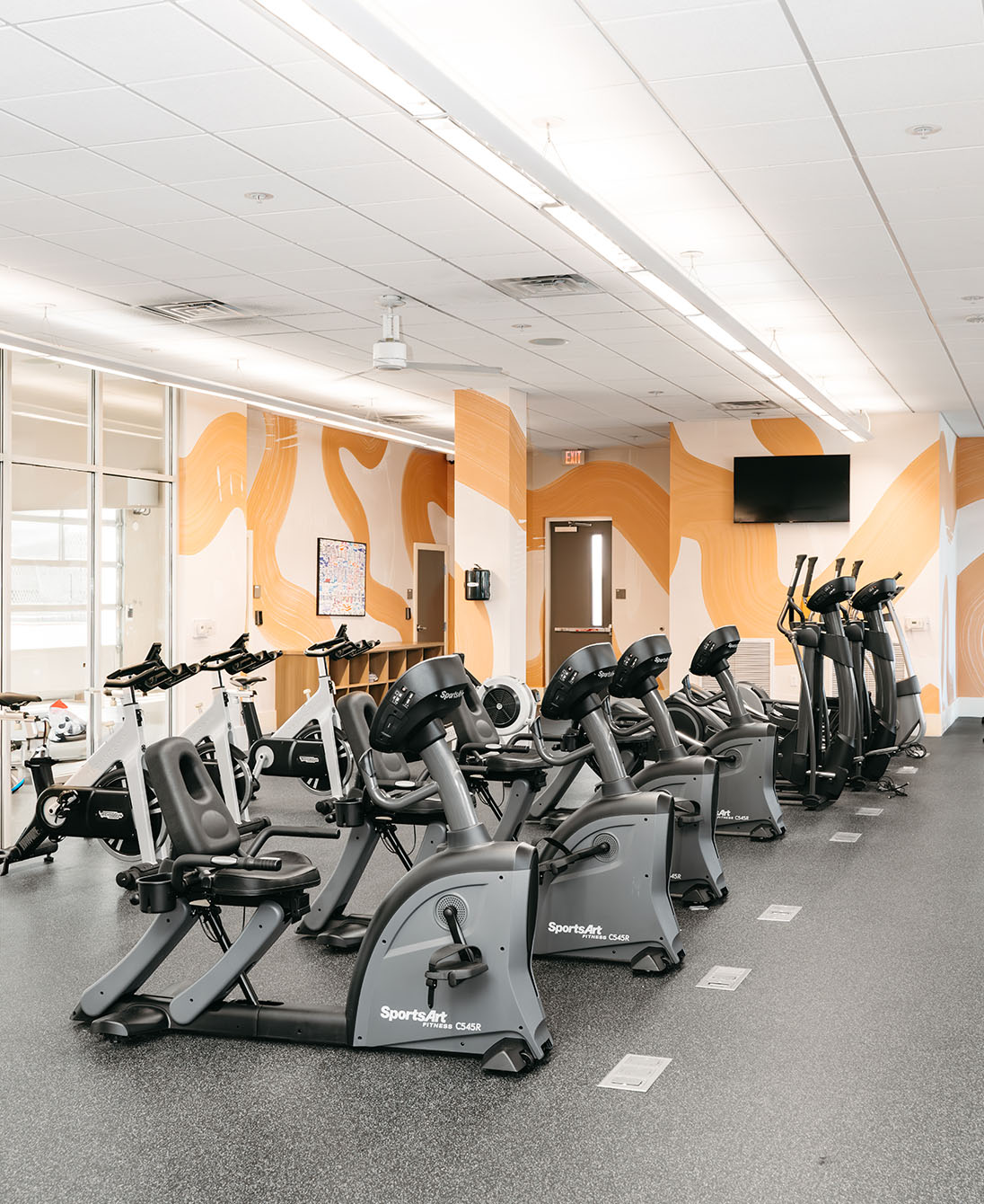 a fitness center with cardio equipment