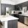 A kitchen with dark brown cabinets