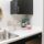 A kitchen with white counters