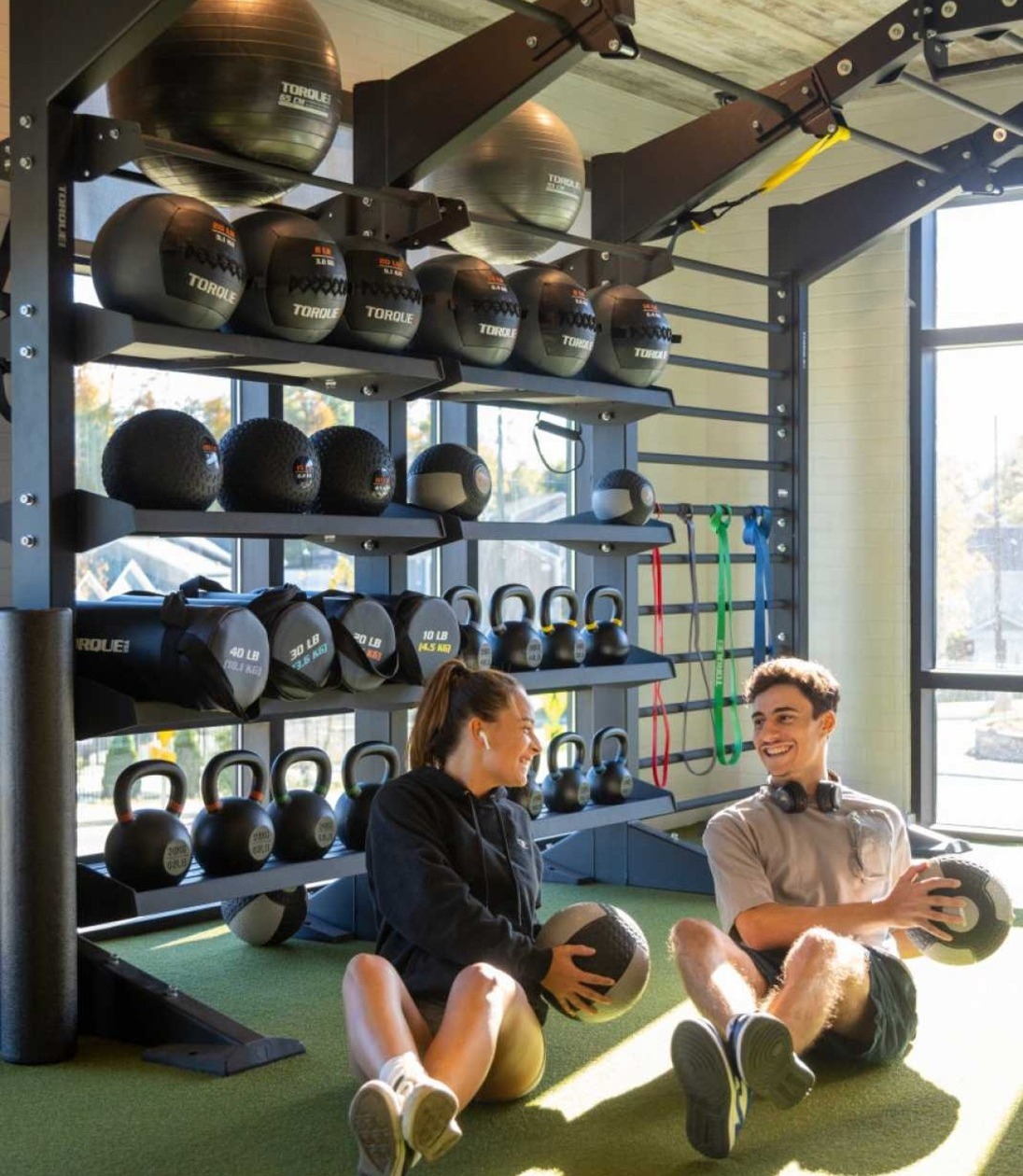 Two friends working out in a fitness center